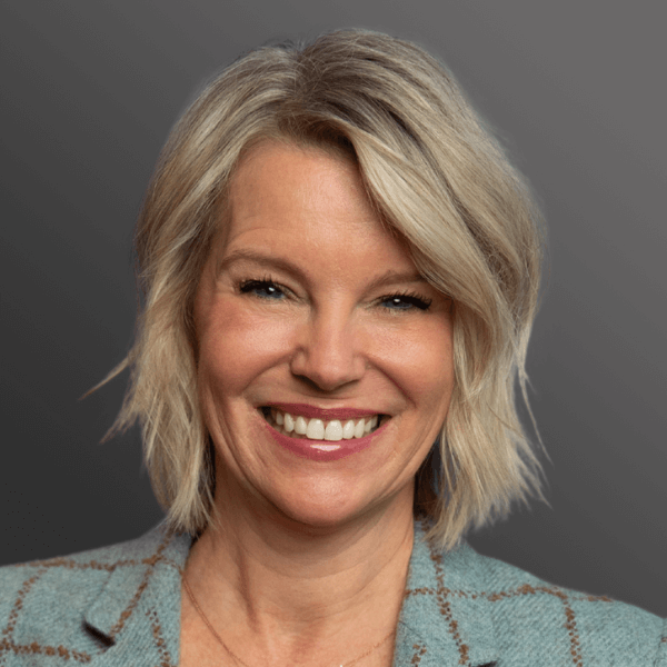 A woman with blonde hair and blue eyes.