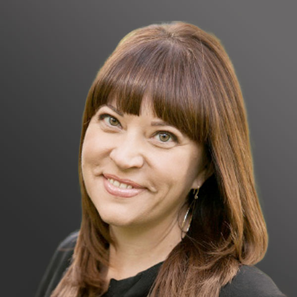 A woman with long brown hair and bangs.
