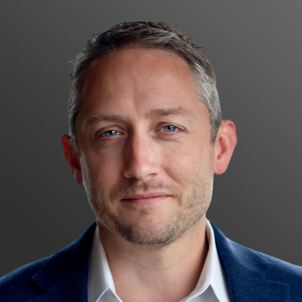 A man with short hair and blue eyes wearing a suit. A man with short hair and blue eyes wearing a suit.