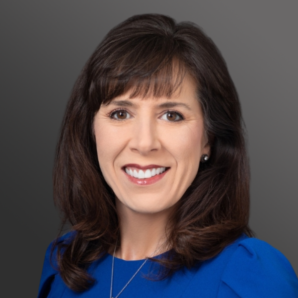 A woman with long hair and a blue shirt.