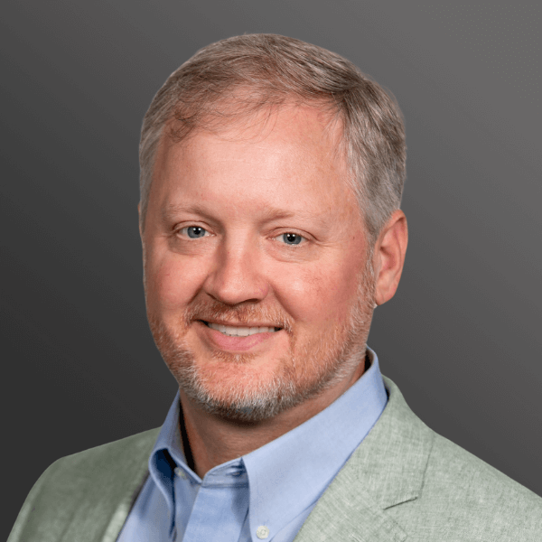 A man with a beard and mustache wearing a jacket