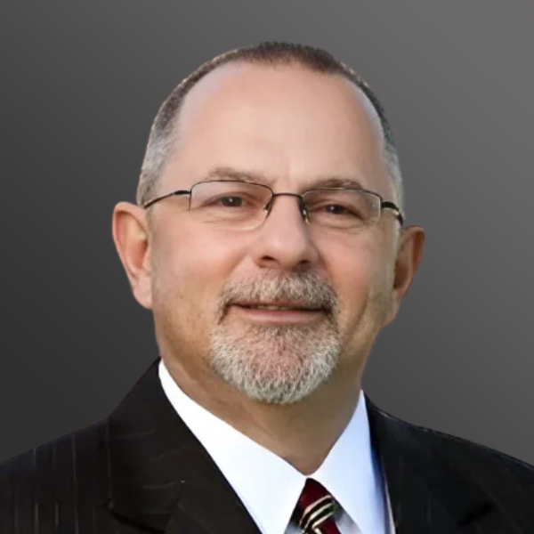 A man in suit and tie with glasses.