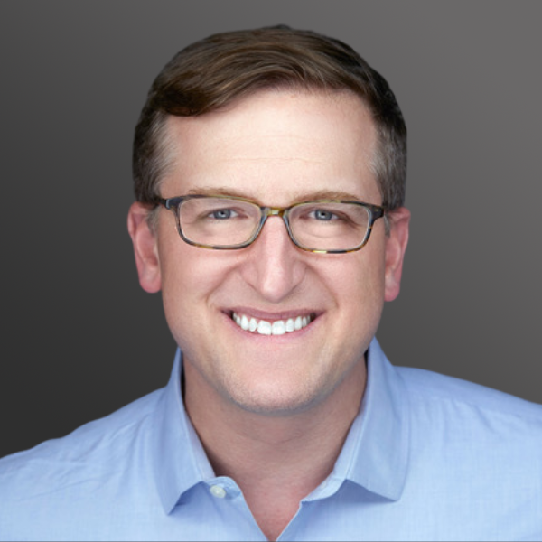 A man with glasses and a blue shirt