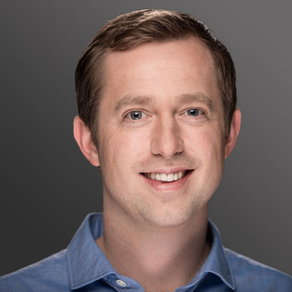 A man with short hair and a blue shirt A man with short hair and a blue shirt