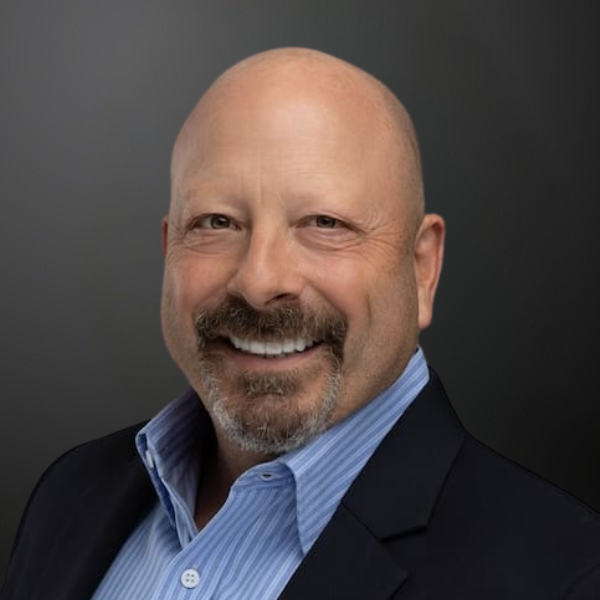 A man with bald head and beard wearing a suit.