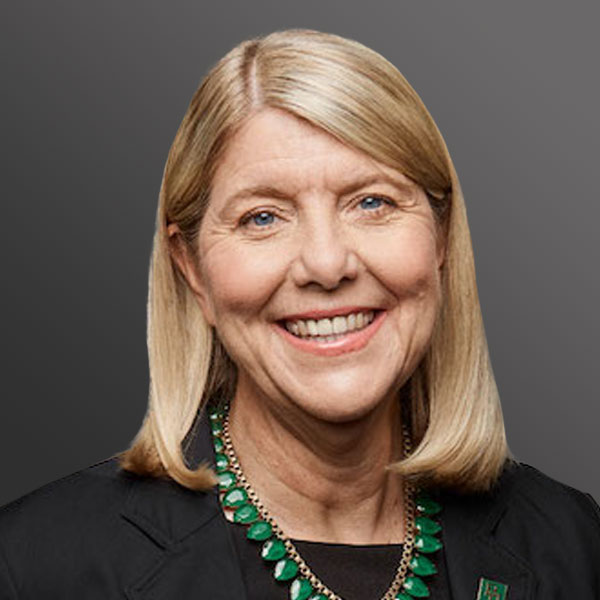 A woman with blonde hair wearing a black jacket.