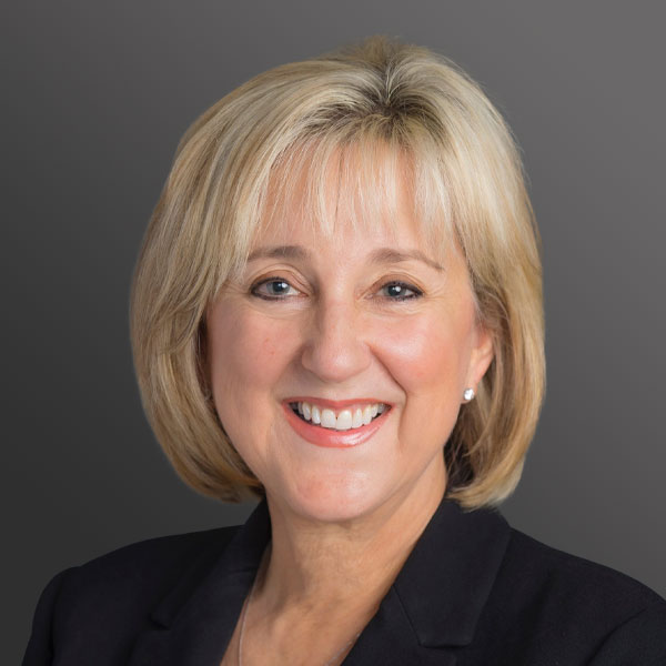 A woman with blonde hair and wearing a black jacket. A woman with blonde hair and wearing a black jacket.