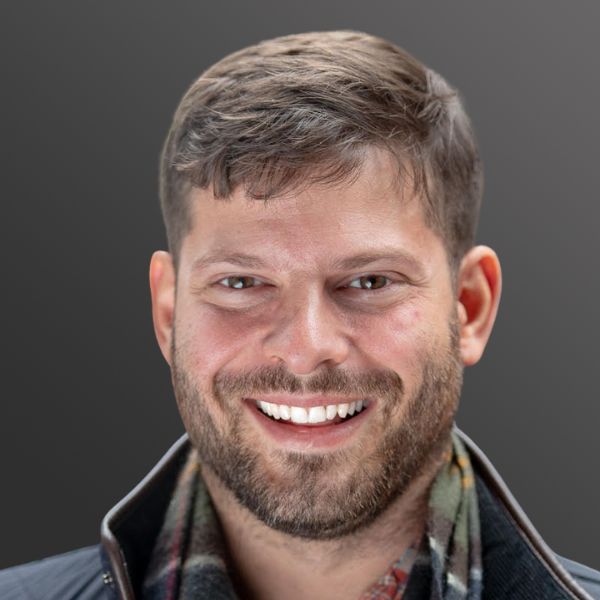 Smiling man with short hair and beard.