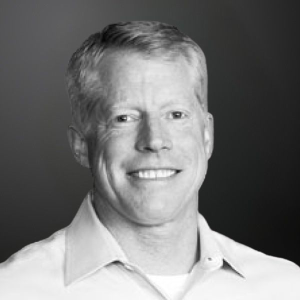 Smiling man in white shirt, black background. Smiling man in white shirt, black background.