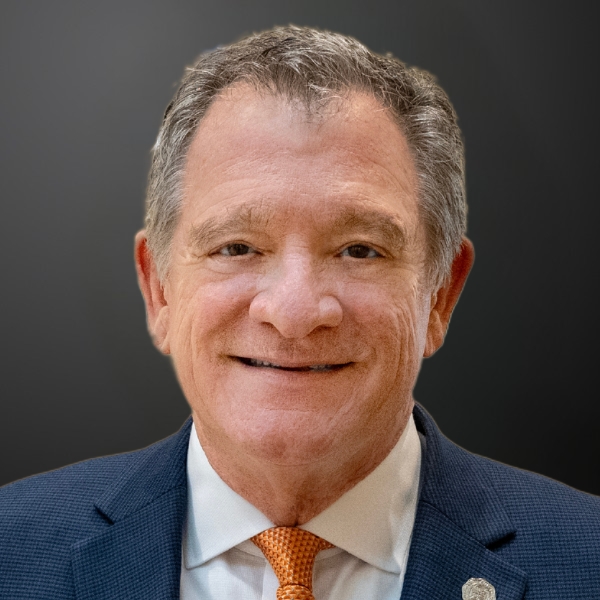 Smiling man in a suit and tie.