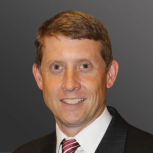 Man wearing a suit and red tie.