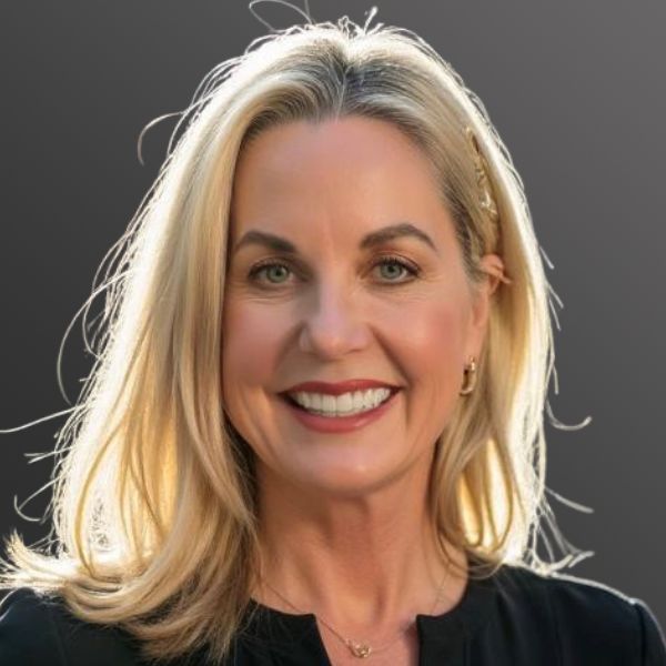 Smiling woman with blonde hair and earrings.