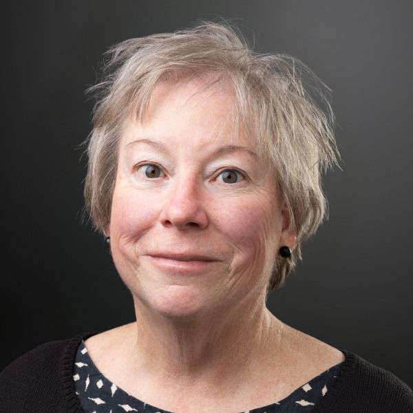 Smiling woman with short gray hair.