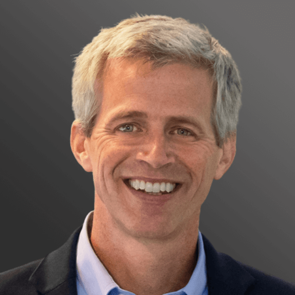 Smiling gray-haired man in navy suit
